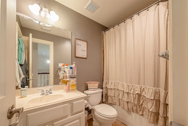 full bathroom featuring tile patterned flooring, shower / bath combo, vanity, and toilet