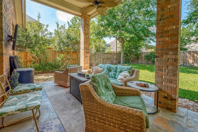 view of patio / terrace featuring ceiling fan and a fire pit