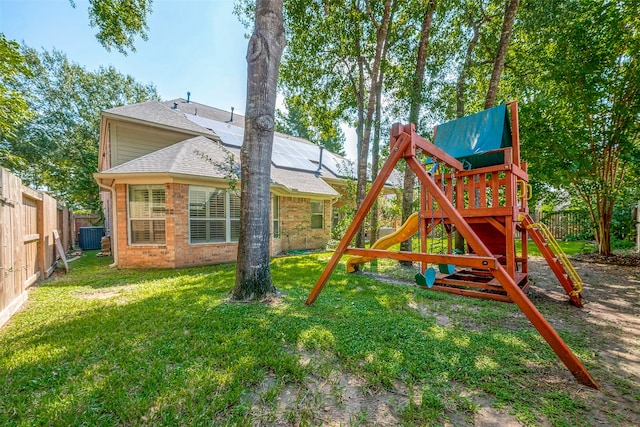 view of playground featuring central AC and a yard