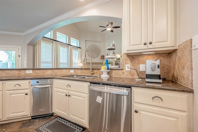 kitchen with dark stone counters, a wealth of natural light, sink, and stainless steel dishwasher