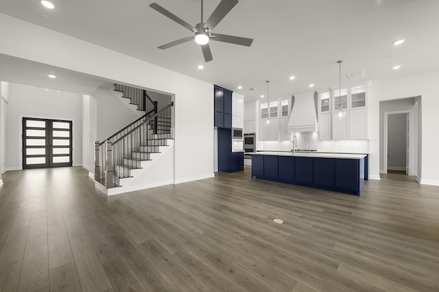 4707 Arbor Park Dr, Manvel, TX 77583 - kitchen featuring premium range hood, open floor plan, a ceiling fan, decorative backsplash, and dark wood-style flooring