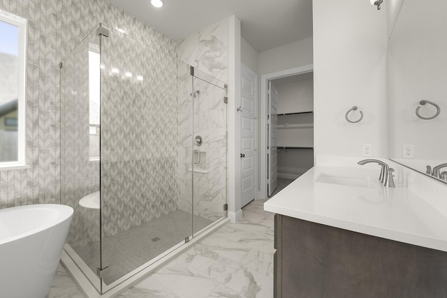 4707 Arbor Park Dr, Manvel, TX 77583 - full bathroom with vanity, marble look tiles, a freestanding tub, a shower stall, and recessed lighting