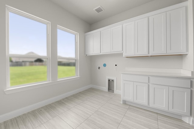 4707 Arbor Park Dr, Manvel, TX 77583 - washroom with hookup for an electric dryer, cabinet space, washer hookup, baseboards, and light tile patterned floors