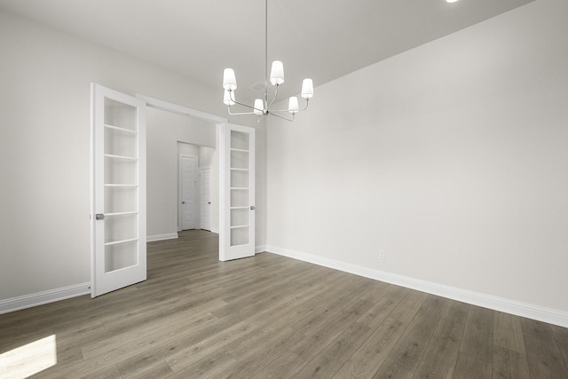 4707 Arbor Park Dr, Manvel, TX 77583 - unfurnished dining area featuring french doors, wood finished floors, a chandelier, and baseboards
