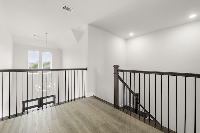 4707 Arbor Park Dr, Manvel, TX 77583 - hall featuring wood finished floors, an upstairs landing, recessed lighting, baseboards, and a chandelier