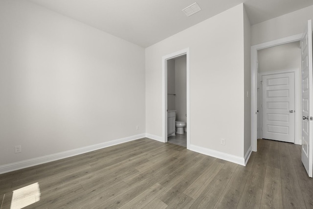 4707 Arbor Park Dr, Manvel, TX 77583 - unfurnished bedroom featuring wood finished floors, baseboards, and ensuite bath