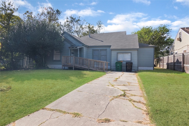 view of front of home featuring a deck and a front lawn