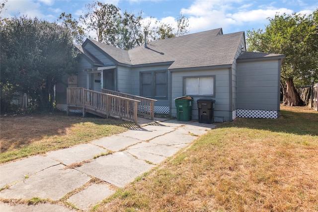 view of front of home with a front lawn and a deck