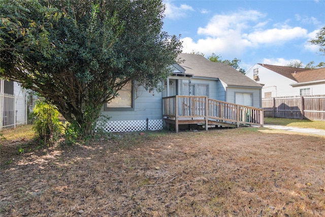 rear view of property featuring a wooden deck