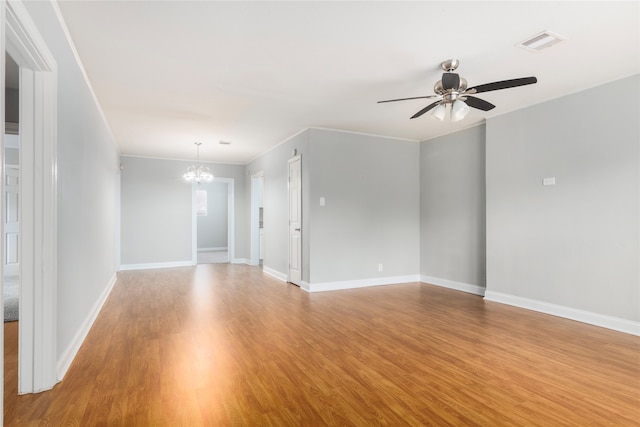 empty room with crown molding, ceiling fan with notable chandelier, and light wood-type flooring