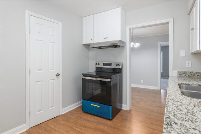 kitchen with light hardwood / wood-style flooring, stainless steel range with electric stovetop, a notable chandelier, white cabinets, and light stone counters