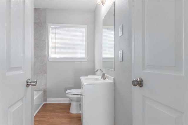 full bathroom with vanity, wood-type flooring, toilet, and bathing tub / shower combination