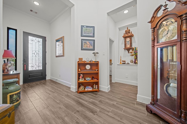 foyer featuring light hardwood / wood-style floors and ornamental molding