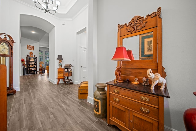 interior space with crown molding, light hardwood / wood-style flooring, and a chandelier