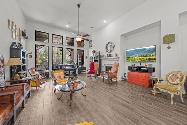 sitting room featuring wood-type flooring and ceiling fan