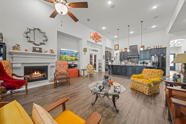 living room with a healthy amount of sunlight, wood-type flooring, and ceiling fan