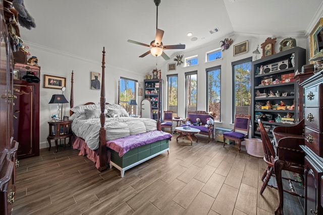 bedroom featuring ceiling fan, hardwood / wood-style flooring, ornamental molding, and vaulted ceiling