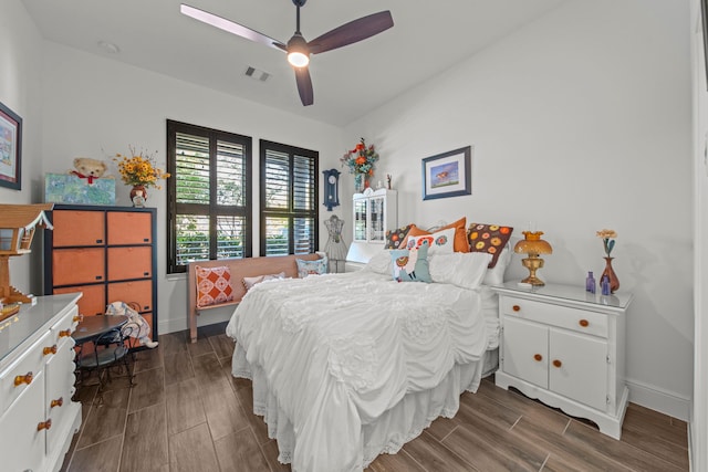 bedroom with dark hardwood / wood-style floors and ceiling fan