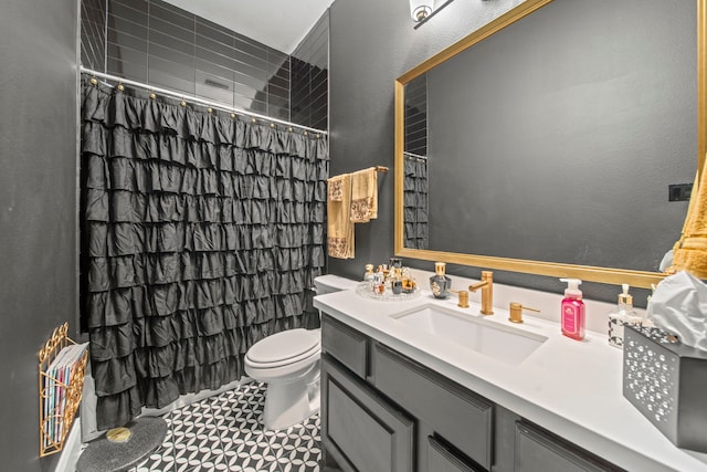 bathroom featuring vanity, toilet, tile patterned floors, and walk in shower