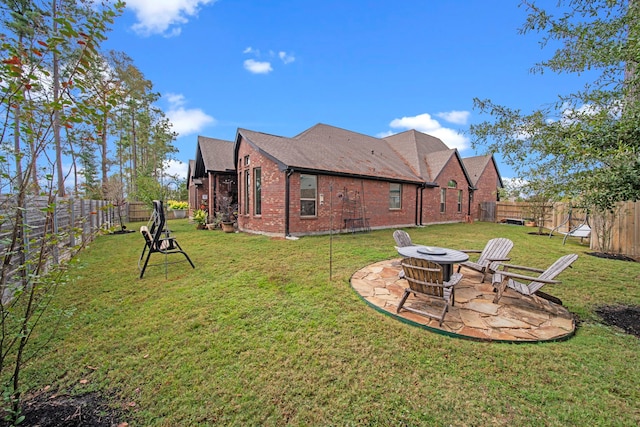 back of house with a patio area, a lawn, and a fire pit