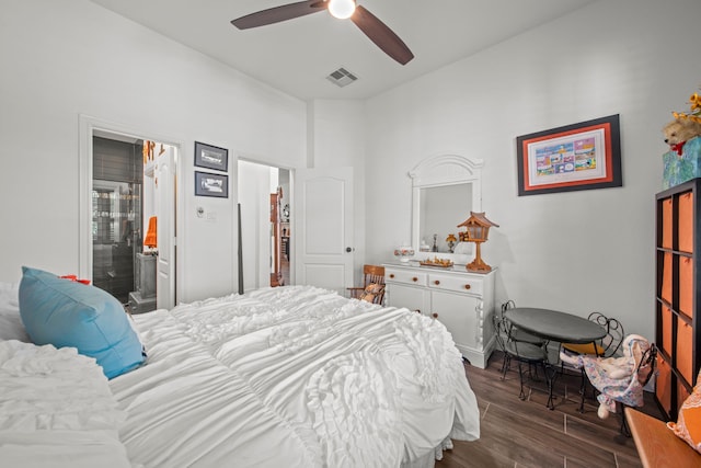 bedroom featuring ensuite bathroom, ceiling fan, and dark hardwood / wood-style flooring