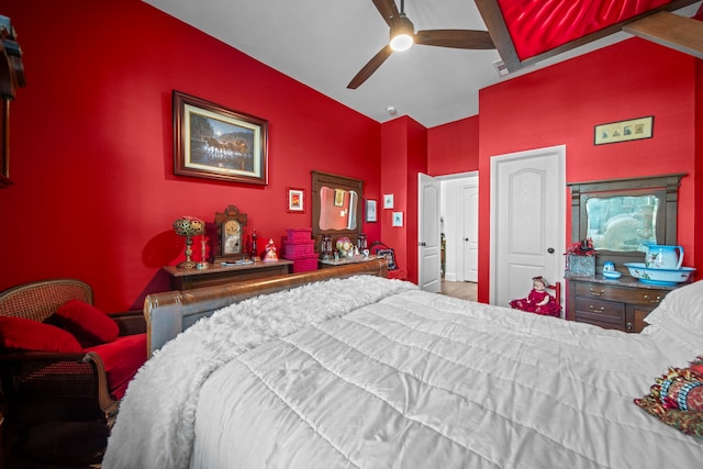 bedroom featuring beamed ceiling, hardwood / wood-style floors, and ceiling fan