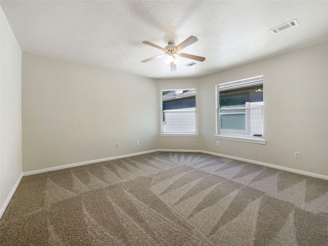 carpeted empty room featuring a textured ceiling and ceiling fan