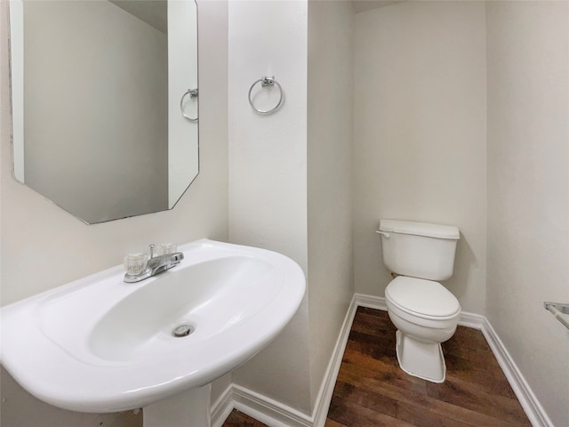 bathroom with sink, hardwood / wood-style flooring, and toilet