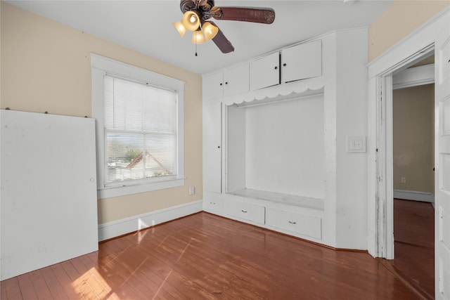 interior space with baseboard heating, hardwood / wood-style flooring, and ceiling fan