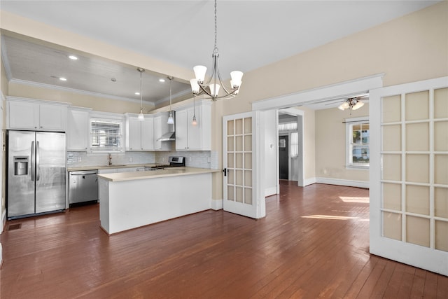 kitchen with dark wood-type flooring, white cabinets, stainless steel appliances, and a healthy amount of sunlight