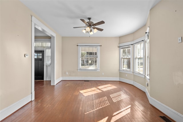 spare room with ceiling fan and hardwood / wood-style floors