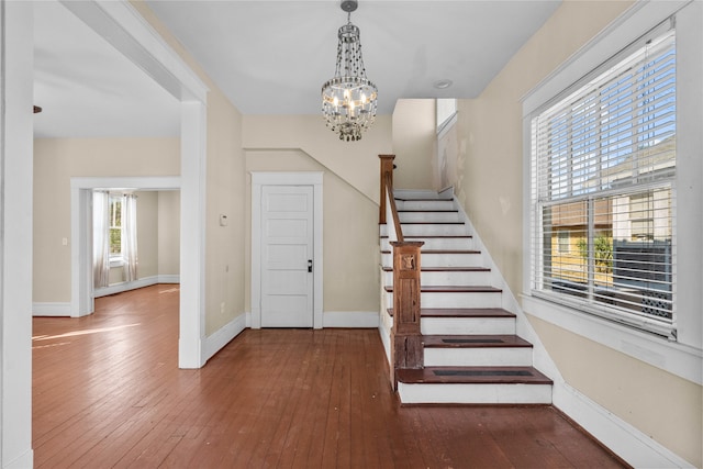 entrance foyer with wood-type flooring and an inviting chandelier