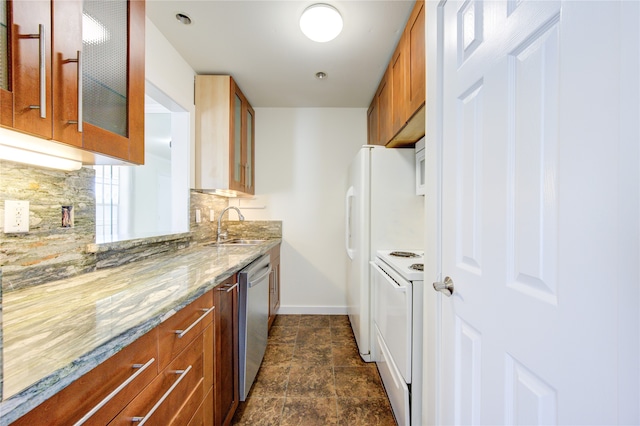 kitchen featuring white appliances, light stone counters, tasteful backsplash, and sink