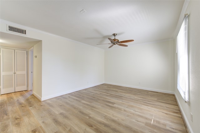 spare room featuring light hardwood / wood-style flooring, ceiling fan, and crown molding