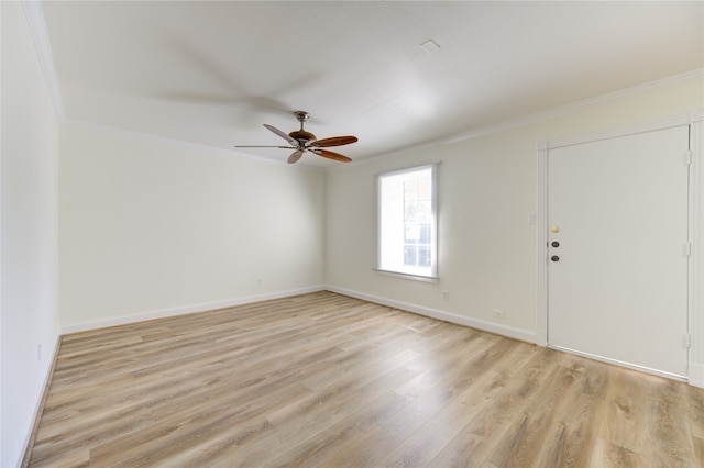 empty room featuring ceiling fan, ornamental molding, and light hardwood / wood-style flooring