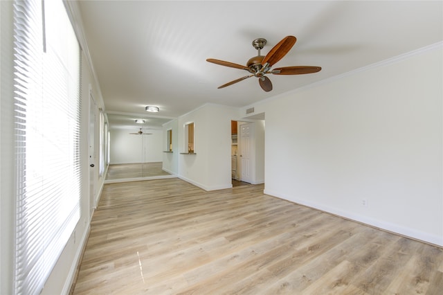 unfurnished living room featuring crown molding, light wood-type flooring, and ceiling fan