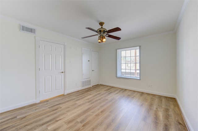 spare room with crown molding, light hardwood / wood-style flooring, and ceiling fan