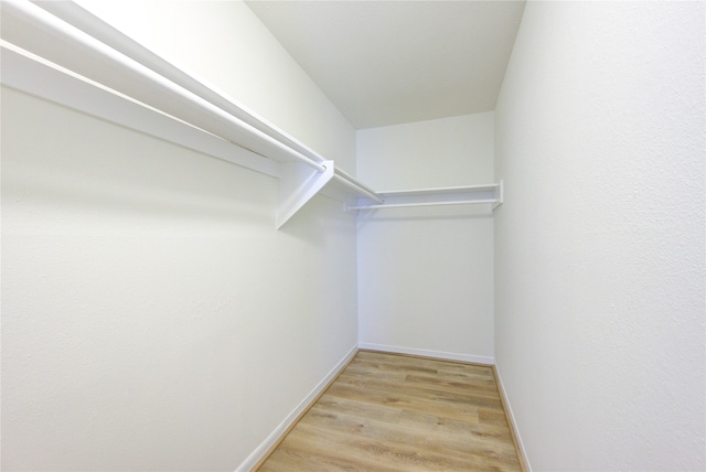 spacious closet with light hardwood / wood-style floors