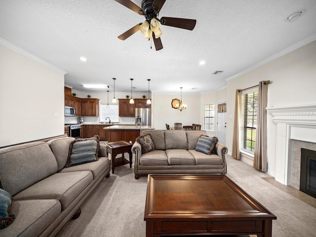 carpeted living room with ornamental molding, a textured ceiling, and ceiling fan with notable chandelier