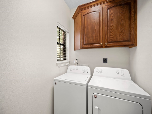 laundry area featuring cabinets and washing machine and clothes dryer