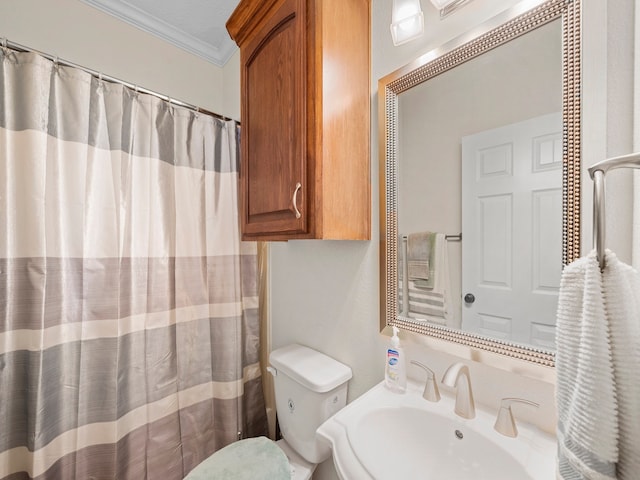 bathroom featuring toilet, crown molding, walk in shower, and sink