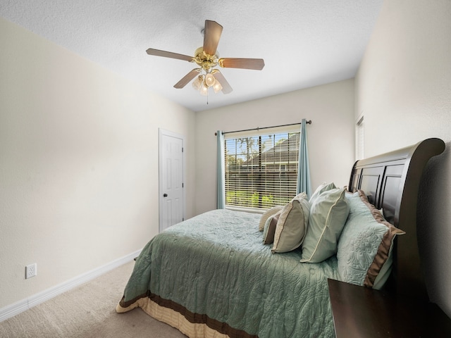 bedroom with a textured ceiling, carpet flooring, and ceiling fan