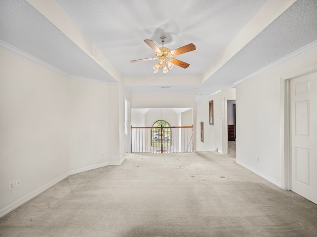 carpeted empty room with ornamental molding, a textured ceiling, and ceiling fan