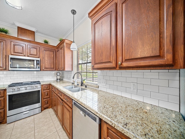 kitchen with light tile patterned floors, stainless steel appliances, sink, crown molding, and decorative light fixtures