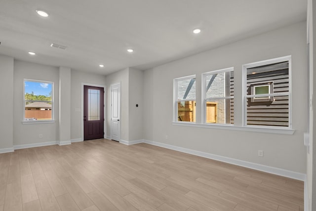 foyer with recessed lighting, baseboards, and light wood finished floors