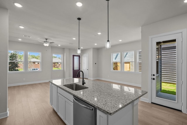 kitchen featuring baseboards, recessed lighting, a sink, light wood-style floors, and stainless steel dishwasher