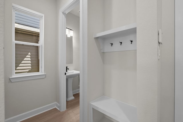 mudroom with baseboards and wood finished floors