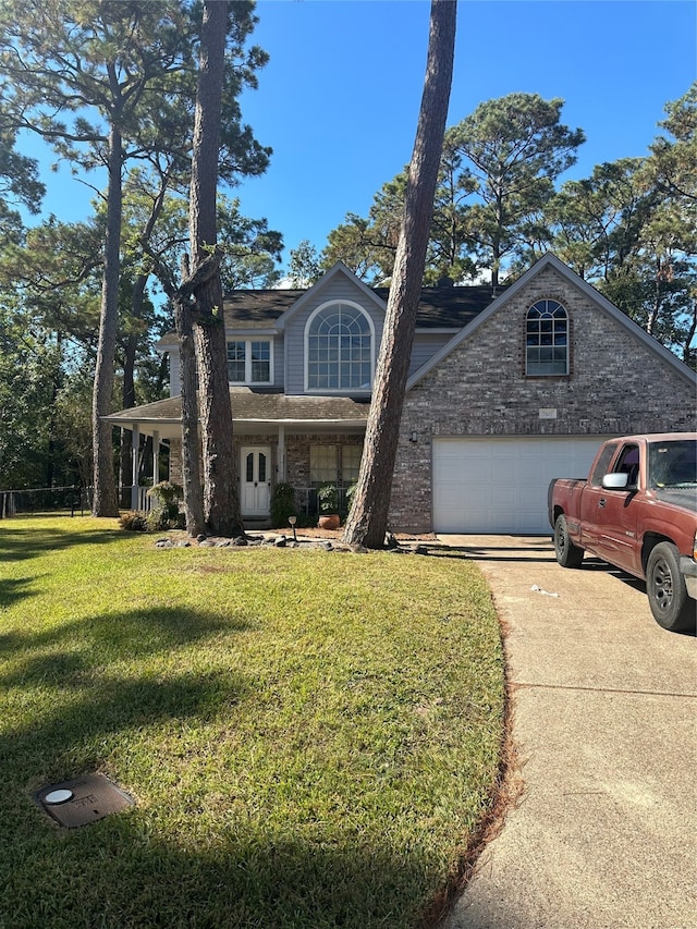 view of front of home with a front yard and a garage