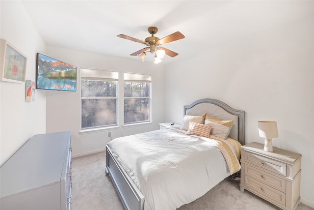 bedroom with ceiling fan and light carpet