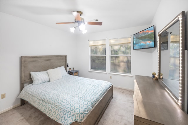 bedroom with ceiling fan and light carpet